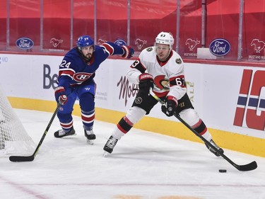 Evgenii Dadonov of the Senators skates the puck away from Phillip Danault of the Canadiens during the first period.