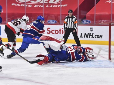 Canadiens goaltender Carey Price dives for the puck during the first period of Thursday's game against the Senators.