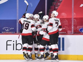 Senators players celebrate the first-period goal by Tim Stuetzle (18).