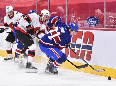 Jake Evans of the Canadiens skates the puck away from Josh Norris of the Senators during the second period.