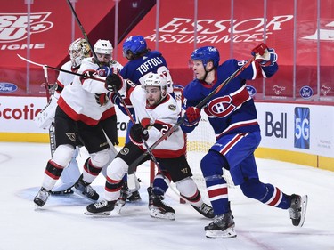 Erik Brannstrom of the Senators and Corey Perry of the Canadiens battle for position during the second period.