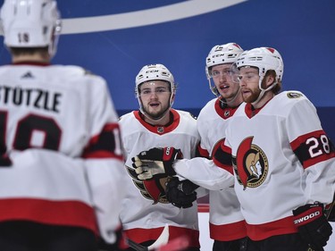 Thomas Chabot (72) of the Senators, second from right, celebrates his first-period goal with teammates Tim Stuetzle, Erik Brannstrom and Connor Brown, right.