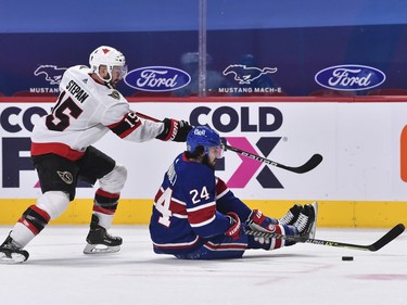 Derek Stepan of the Senators and Phillip Danault of the Canadiens battle for the puck in the third period.