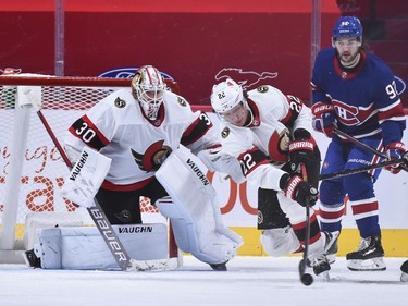 Senators defenceman Nikita Zaitsev clears the puck in front of goaltender Matt Murray and Canadiens forward Jonathan Drouin in the third period.
