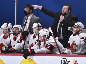 Head coach of the Ottawa Senators D. J. Smith pulls down his mask to call out instructions against the Montreal Canadiens during the third period at the Bell Centre on February 4, 2021 in Montreal, Canada.  The Ottawa Senators defeated the Montreal Canadiens 3-2.