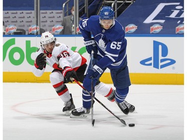 Colin White (left)of the Ottawa Senators competes for the puck against Illya Mikheyev of the Toronto Maple Leafs during an NHL game at Scotiabank Arena on Monday in Toronto.