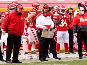 Offensive coordinator Eric Bieniemy, middle, stands next to Chiefs head coach Andy Reid on the sideline during a regular-season game against the Atlanta Falcons on Dec. 27.
