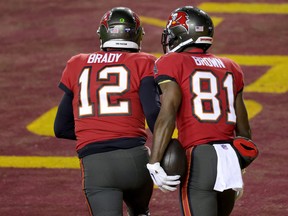 Quarterback Tom Brady and wide receiver Antonio Brown of the Tampa Bay Buccaneers celebrate after connecting for a  touchdown pass  in the NFC wild card playoff game.