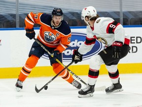 Edmonton Oilers' Connor McDavid battles Ottawa Senators' Josh Norris during third period NHL action at Rogers Place in Edmonton, on Tuesday, Feb. 2, 2021.