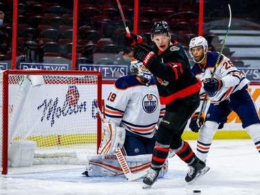 Senators left-winger Brady Tkachuk celebrates Connor Brown's first-period goal n front of Oilers netminder Mikko Koskinen and defenceman Darnell Nurse.