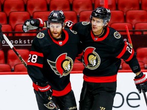 Senators defenceman Nikita Zaitsev (22) congratulates right-winger Connor Brown after a goal.