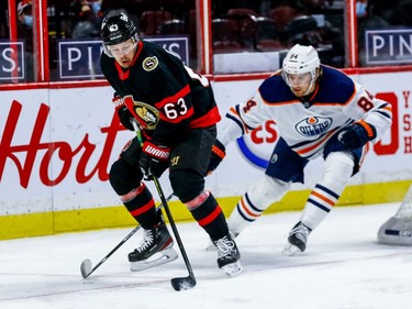 Senators right-winger Evgenii Dadonov (63) eludes the check of Oilers defenceman William Lagesson in first-period action.