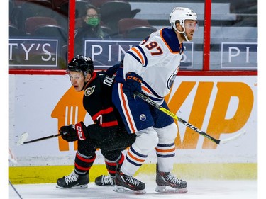Senators left-winger Brady Tkachuk sticks close to Oilers centre Connor McDavid in the first period.