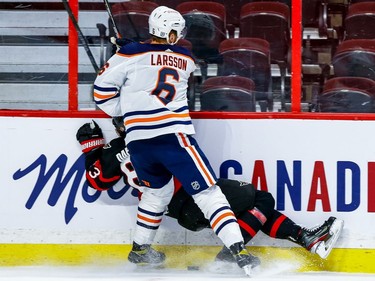 Oilers defenceman Adam Larsson checks Senators right-winger Evgenii Dadonov in the first period.