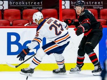 Senators left-winger Brady Tkachuk (7)) works the puck past Oilers defenceman Darnell Nurse in the first period.