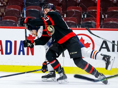 Senators left-winger Nick Paul battles for position against Oilers defenceman Adam Larsson in the first period.