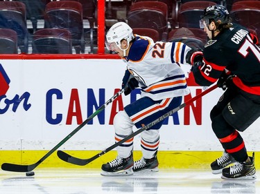 Senators defenceman Thomas Chabot pursues Oilers defenceman Tyson Barrie along the boards during the second period.