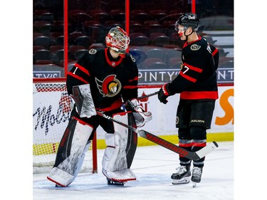 Senators left-winger Brady Tkachuk gives netminder Marcus Hogberg a stick tap as he leaves the crease after being replaced during the second period.