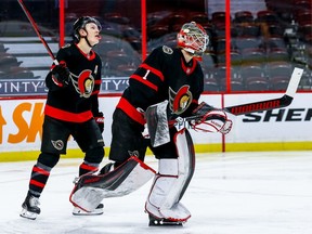 Senators left-winger Brady Tkachuk looks up at the video board as goaltender Marcus Hogberg heads to the bench after being pulled in favour of Matt Murray in the second period.