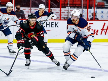 Senators right-winger Evgenii Dadonov attempts to check Oilers centre Connor McDavid in the second period.