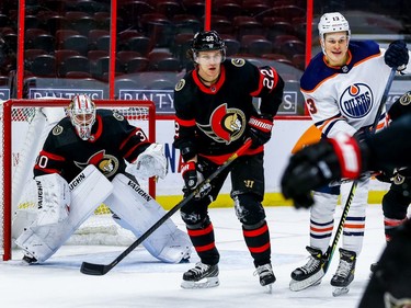 Senators goaltender Matt Murray, who entered the game in place of Marcus Hogberg in the second period, tracks the play without his goal stick as defenceman Nikita Zaitsev defends against Oilers right-winger Jesse Puljujarvi.