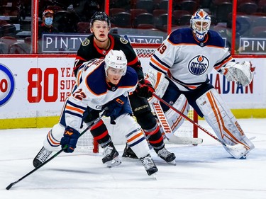Senators left-winger Brady Tkachuk tries to hold his position in front of the between Oilers defenceman Tyson Barrie (22) and goaltender Mikko Koskinen (19) in the third period.