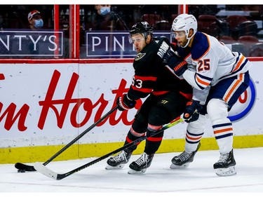 Senators right-winger Evgenii Dadonov (63) keeps the puck away from Oilers defenceman Darnell Nurse in the third period.
