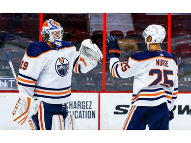 Oilers goaltender Mikko Koskinen is congratulated by teammate Darnell Nurse after protecting Tuesday's 3-2 victory against the Senators at Canadian Tire Centre.
