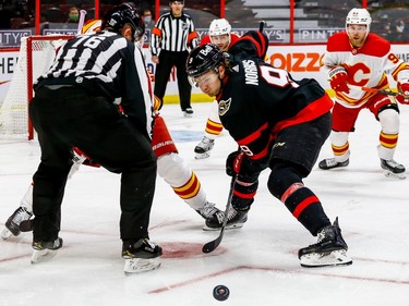 Ottawa Senators center Josh Norris wins a draw against the Calgary Flames during first period action at the Canadian Tire Centre on Thursday.