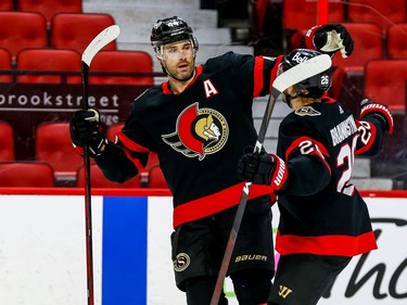Ottawa Senators defenceman Erik Gudbranson (left) is congratulated on his goal against then Calgary Flames by Ottawa Senators defenceman Erik Brannstrom during the first period at the Canadian Tire Centre on Thursday.
