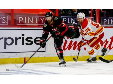 Ottawa Senators left wing Austin Watson (left) eludes the check of Calgary Flames defenceman Noah Hanifin at the Canadian Tire Centre on Thursday.