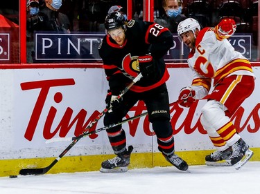 Ottawa Senators right wing Connor Brown (left) eludes the check of Calgary Flames defenceman Mark Giordano.