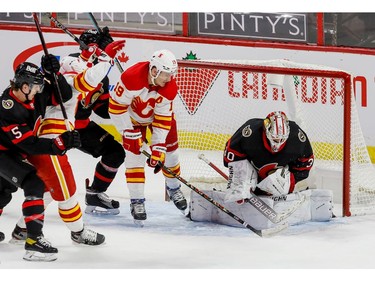 Calgary Flames left wing Matthew Tkachuk (19) looks for a rebound off of Ottawa Senators goaltender Matt Murray in the first period on Thursday.