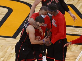 Raptors guard Fred VanVleet (23) is congratulated by Toronto Raptors forward Pascal Siakam (43) and teammates as he makes a three-point basket during the second half at Amway Center on Tuesday.