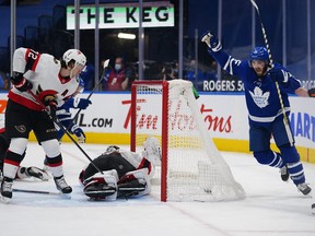 Toronto Maple Leafs forward Alex Kerfoot  celebrates scoring a third -period goal on  Senators goaltender Matt Murray as defenseman Thomas Chabot looks on at Scotiabank Arena on Wednesday.