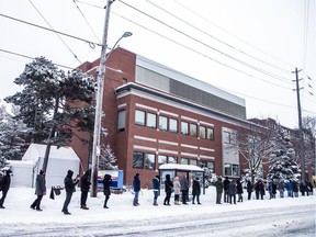 Eligible vaccine recipients, mostly frontline workers, lined up outside The Ottawa Hospital Civic Campus, Saturday Feb. 27, 2021, in the snowstorm that hit the capital, to receive their much anticipated COVID-19 vaccine.