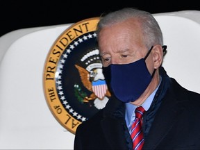 In this file photo taken on Feb. 5, 2021, U.S. President Joe Biden steps off Air Force One upon arrival at New Castle Airport in New Castle, Del.