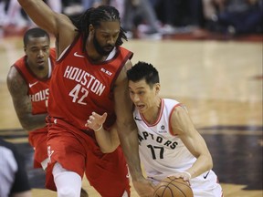 In this March 5, 2019 file photo, Toronto Raptors guard Jeremy Lin, right, and Houston Rockets centre Nene Hilario are pictured during a game at the Scotiabank Arena in Toronto.