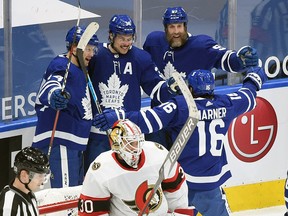Maple Leafs' Auston Matthews (34) is greeted by teammates after scoring on Ottawa Senators goalie Matt Murray in the first period at Scotiabank Arena on Thursday, Feb. 18, 2021.