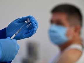 A health worker prepares a COVID-19 vaccine.