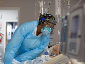 FILE: A healthcare worker comforts a patient.