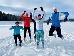 Athletes jump in the snow as they wear woollen socks instead of footwear during their training in Espoo, Finland February 14, 2021.