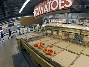 People shop depleted produce aisles in Central Market in Fort Worth, Texas, Thursday, Feb. 18, 2021.