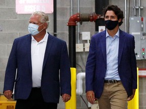 Ontario Premier Doug Ford and Prime Minister Justin Trudeau walk together in August 2020.