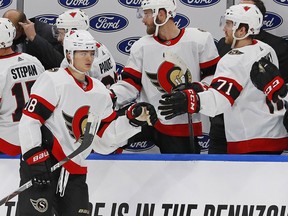 Senators forward Tim Stuetzle celebrates with teammates after scoring a goal against the Oilers in Sunday's game at Edmonton.