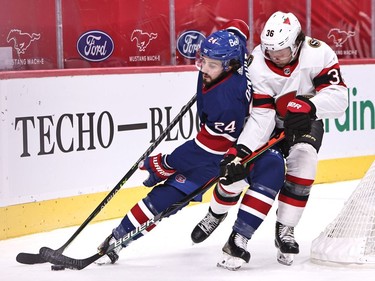 Canadiens forward Phillip Danault (24) and Senators centre Colin White battle for the puck during the first period.