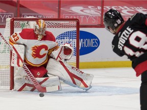 Calgary Flames goalie David Rittich (33) makes a save on a shot by Ottawa Senators left wing Tim Stutzle (18) in the second period at the Canadian Tire Centre.