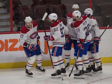 Canadiens players celebrate the go-ahead goal in the third period by right-winger Josh Anderson (17).