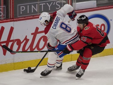 Canadiens defenceman Ben Chiarot controls the puck against Senators right-winger Evgenii Dadonov in the third period.