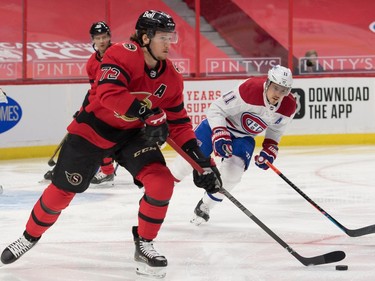 Senators defenceman Thomas Chabot skates with the puck in front of Canadiens right-winger Brendan Gallagher in the first period.